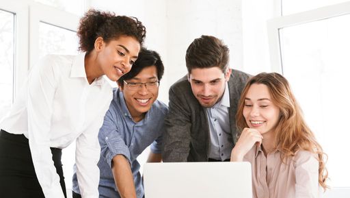 People crowded around a laptop
