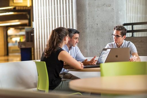 Students speaking with a professor