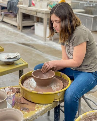 Ceramics student makes bowls for the Empty Bowls fundraiser in New Bedford