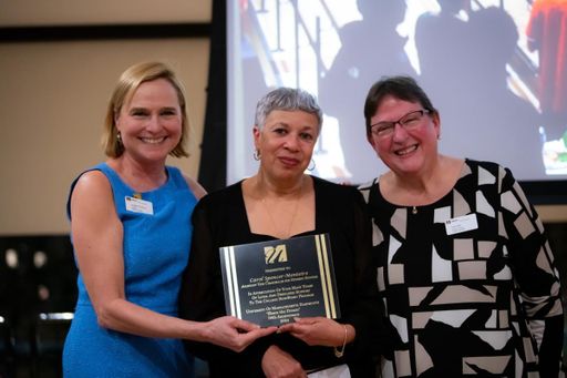 Assistant Vice Chancellor for Student Success Carol Spencer-Monteiro accepts an Award of Appreciation.