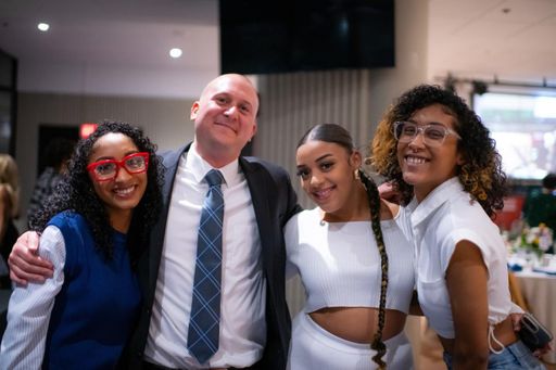 College Now Director Craig Elkins poses with students.