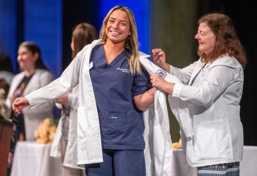 Nursing student receives her white coat at the annual White Coat Ceremony