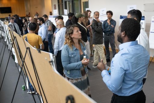 Students standing by posterboards showcasing research