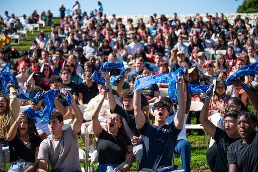 students wave bandanas at new student convocation