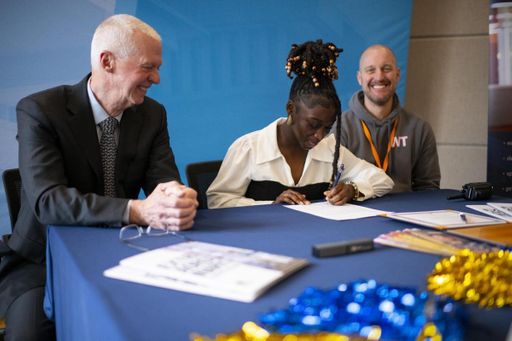 Audrey signing her acceptance letter at the Founders' Signing Day