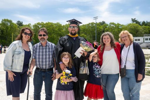 A student poses with his family at Commencement.