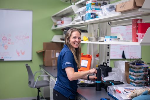 Dr. Lauran Brewster in her lab with the acoustic receivers that will be used in her research