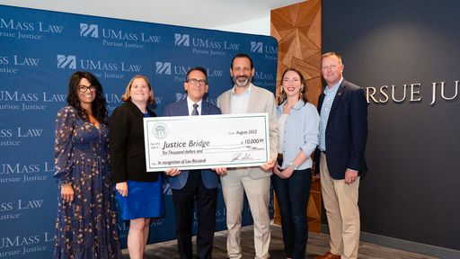 UMass Law Dean Sam Panarella, students Rebecca Wood and Chelsee Rennie, and President and CEO of Bristol Wealth Group Lou Ricciardi pose with Bristol Wealth Group executives.