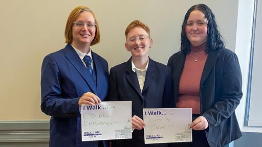 UMass Law students pose with the reason they walk—for equal employment and for access to justice.