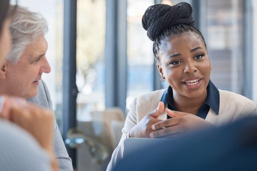 Woman at a meeting with coworkers.