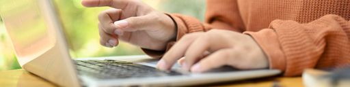 Close-up of typing on a laptop