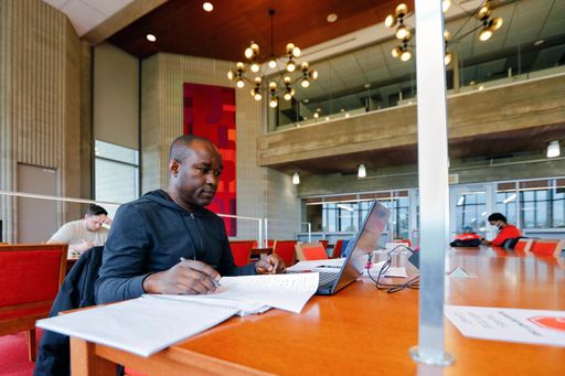 UMassD student studying in the library