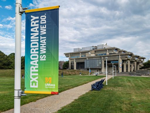 photo of lamppost banner with library in background