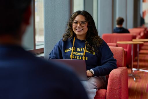 UMassD student studying in the library