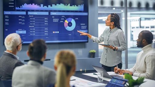 Diverse Modern Office: Female Digital Entrepreneur Uses TV Screen to Discusses Strategy with team