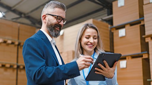 Warehouse manager talking with logistics employee