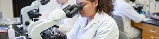 Student using a microscope in the lab