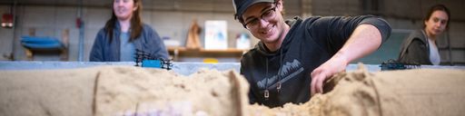 Civil Engineering students working on a concrete canoe in the ASCE lab