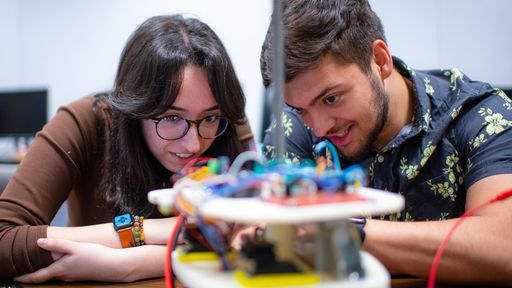 Electrical Engineering student, Erika Caushi '23 MS '24 and Computer Science student, Cameron McAlpine '23, working in the lab