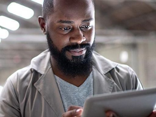 Focused manager using digital tablet in a factory