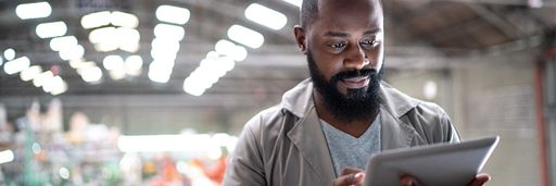 Focused manager using digital tablet in a factory