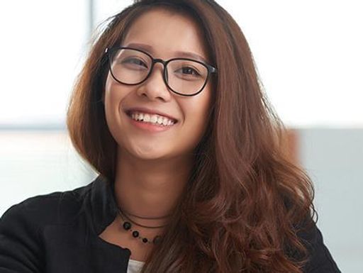 Portrait of cheerful Asian young lawyer working in office