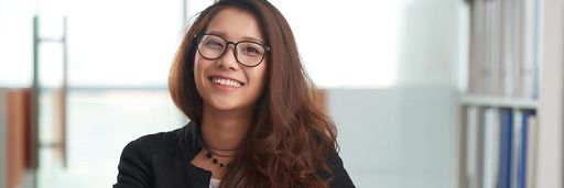 Portrait of cheerful Asian young lawyer working in office