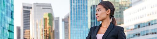 Business woman standing in front of city buildings