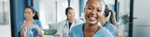 Nurse smiling and sitting in a meeting room
