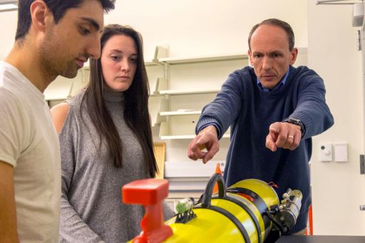 Professor Daniel MacDonald working with his research team.