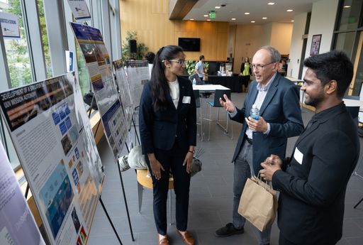 Prof. Daniel MacDonald and his graduate students were discussing in front of their poster.