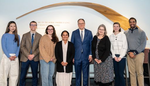 UMass Law students pose with judges in the UMass Law lobby.