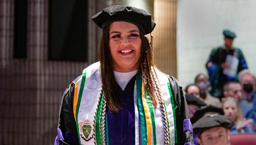 Law student standing up at graduation ceremony