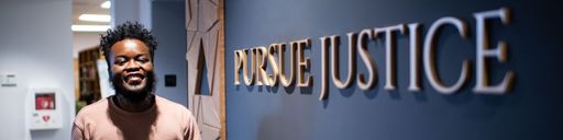 UMass Law student, Rbrey Singleton JD candidate '22, walking through the Arc of Justice Atrium