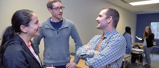 Law School Professor Jason Potter Burda speaking with students after class