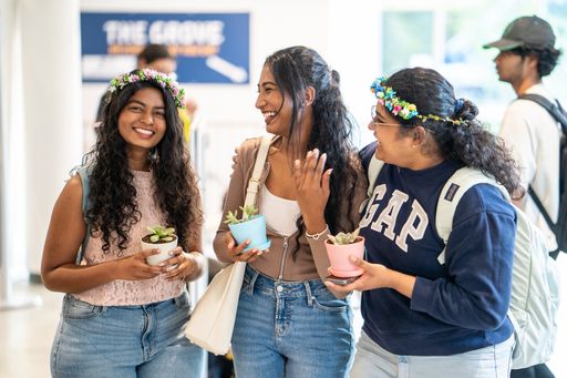 Three students pictures in the Grove during Weeks of Welcome.