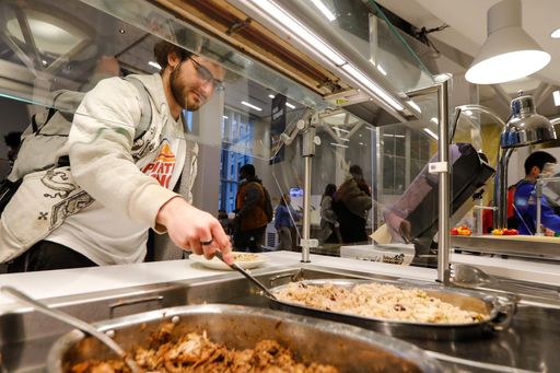 Student getting food at the Grove food counter
