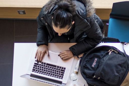 Student studying in the Charlton College of Business Learning Pavilion 