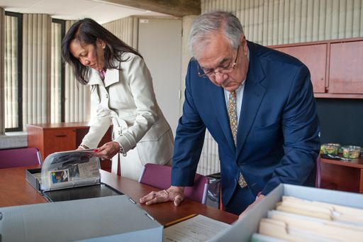Barney Frank looking over items at the Barney Frank Collection at UMass Dartmouth
