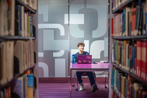 Jake Paris, Civil Engineering student and member of the track and field/cross country team, studying in the library