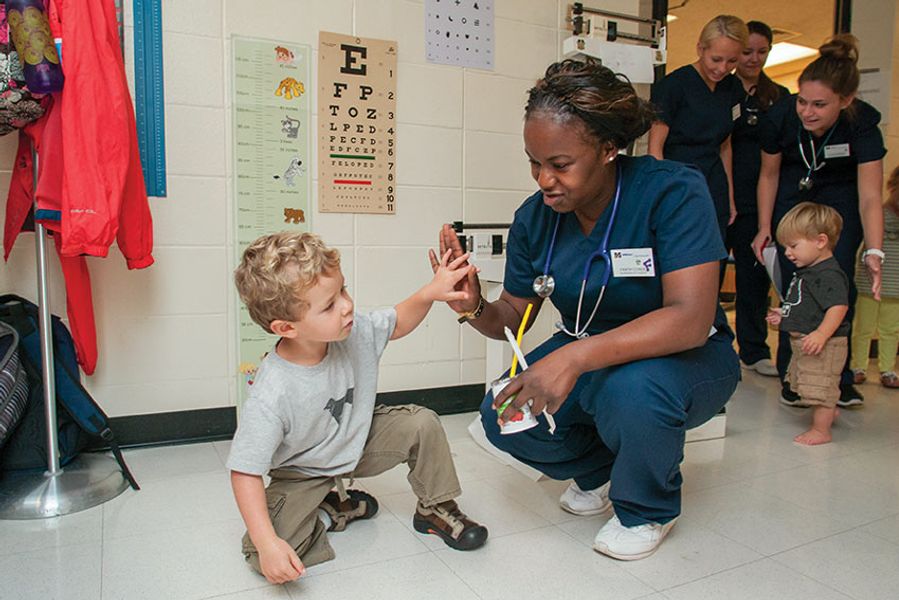 Nurse and little boy in lab