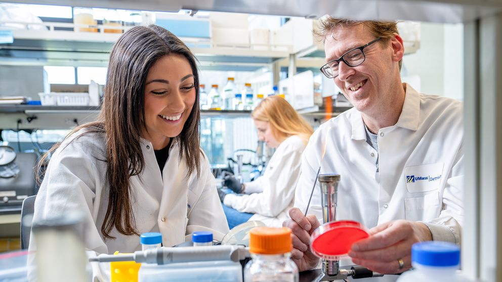Biology Professor, Mark Silby, working with student, Yousra Bendarkawi MS '24, in the lab