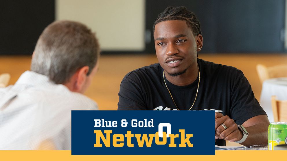 UMass Dartmouth senior interacting with a alumni at Senior Shift.