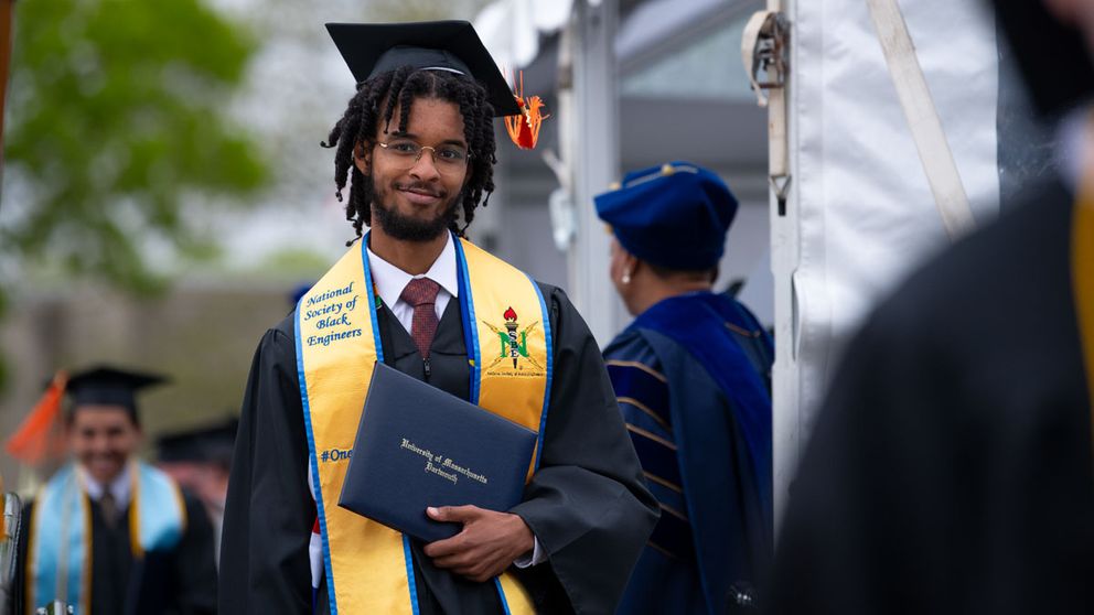 Engineering student at commencement accepting his diploma