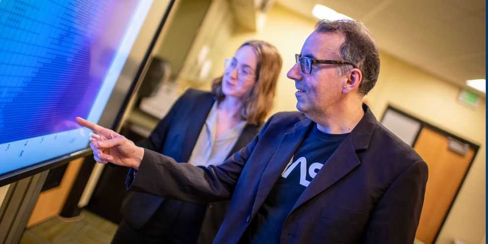 Professor Robert Fisher and Physics student McKenzie Ferrari discussing research in the Center for Scientific Computing and Data Science Research