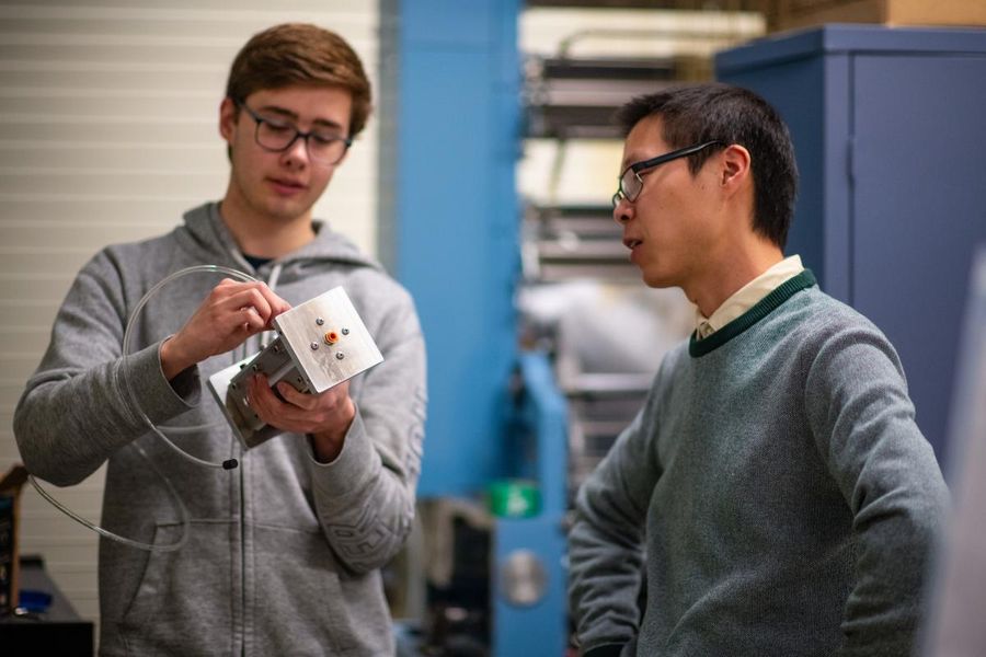 Mechanical Engineering student James Bonnell in the lab with Prof. Hangjian Ling