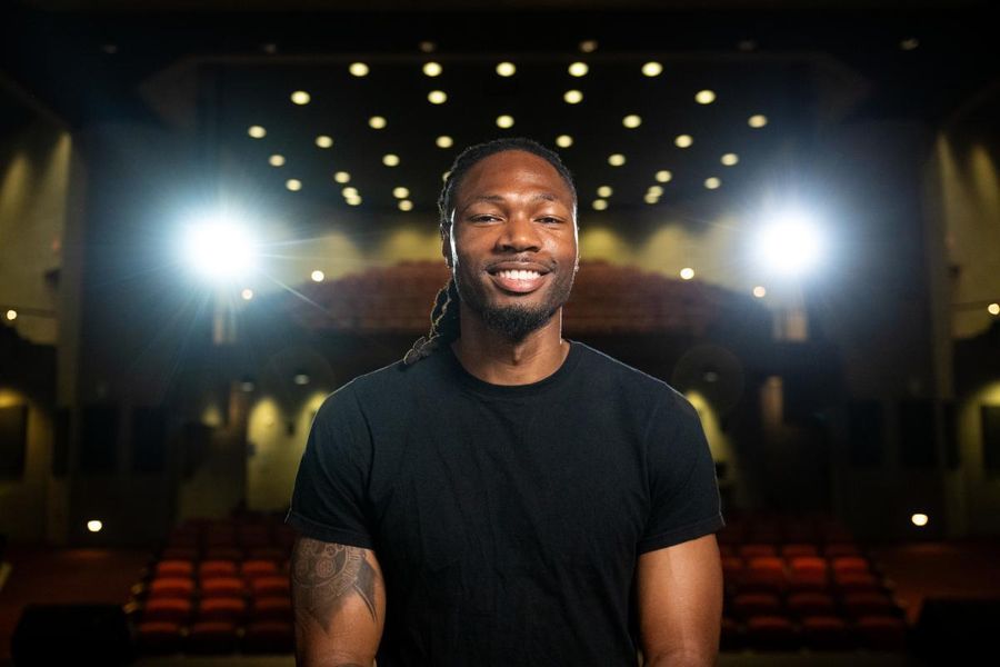 Sam Riley pictured seated in the campus auditorium.