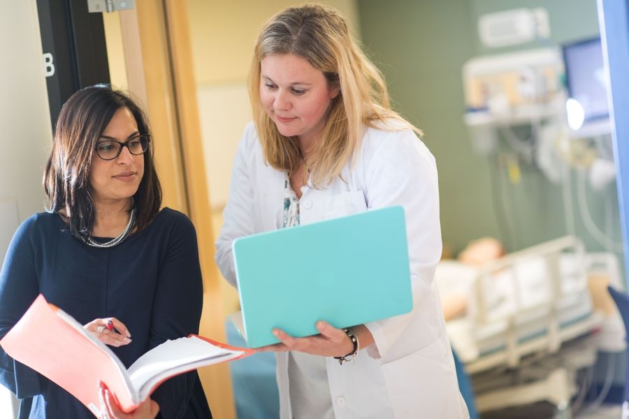 Two Nursing PhD students conversing.