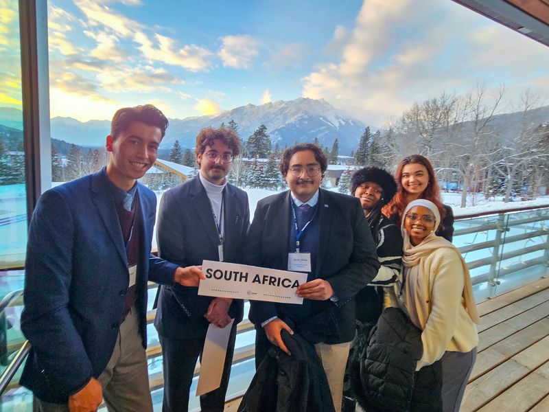 Model UN members posing for a group photo with a sign that read South Africa