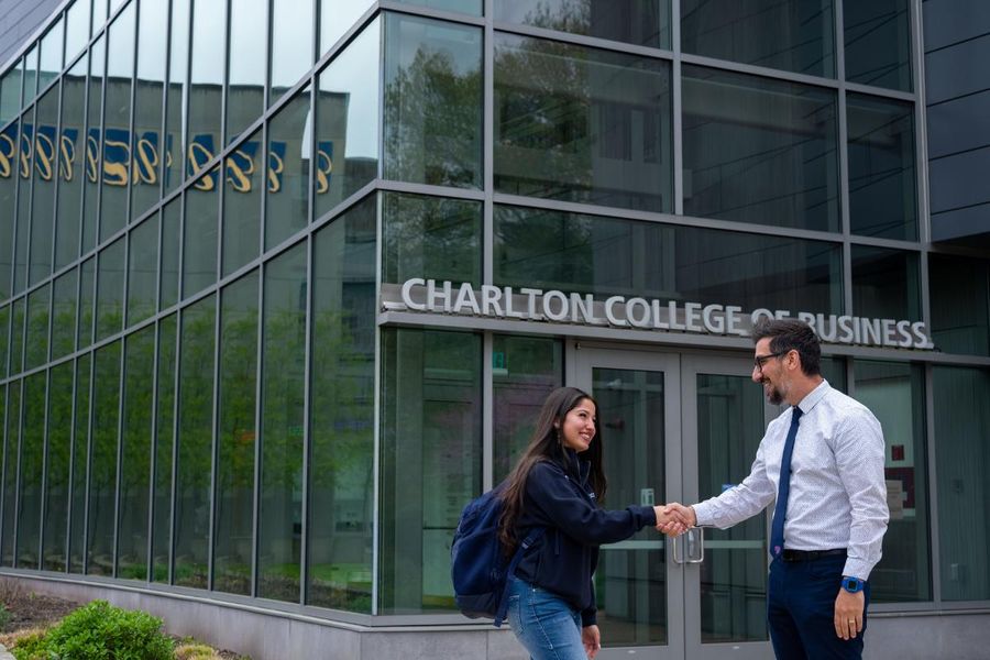 CCB exterior handshake faculty student